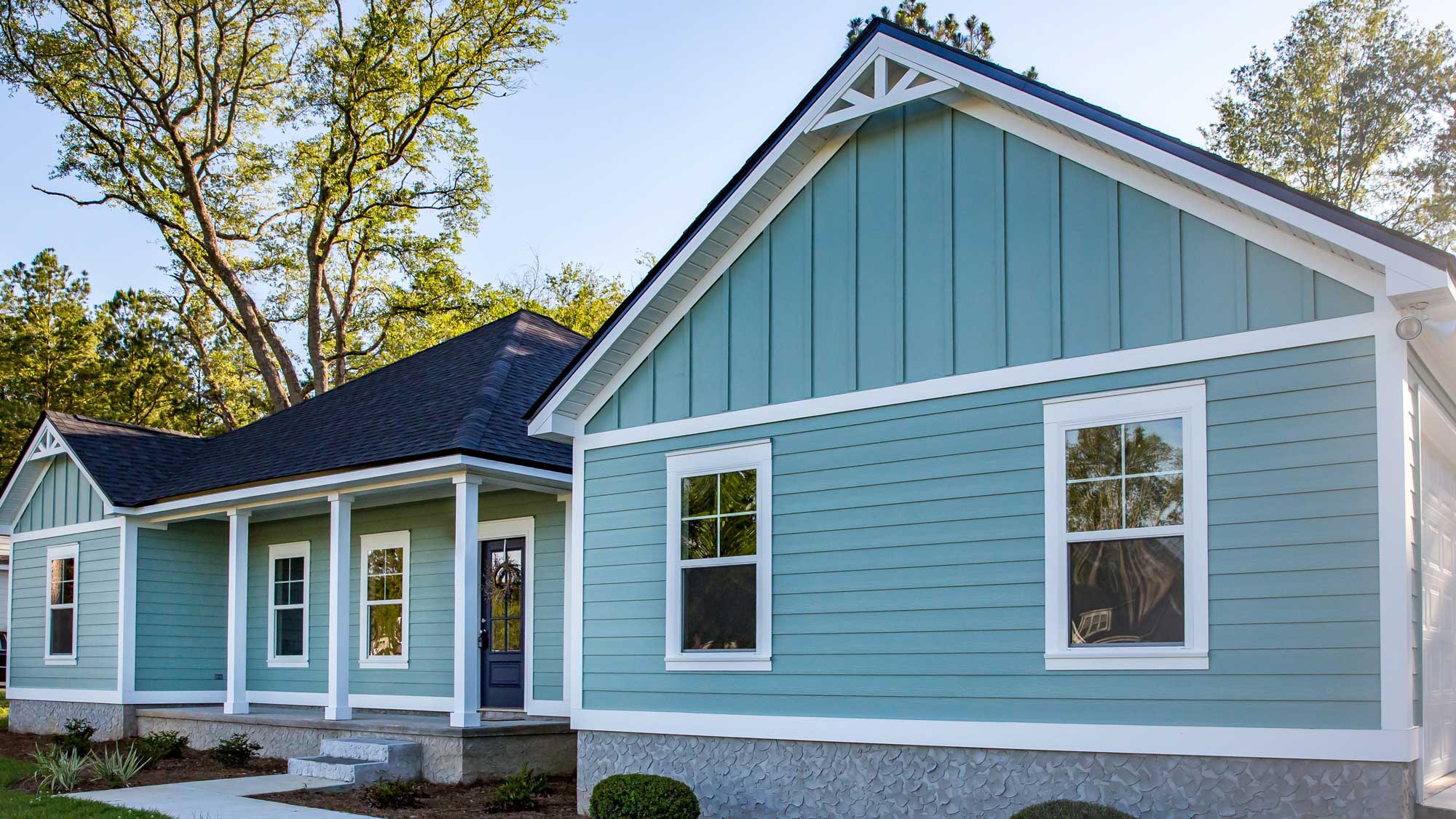 The exterior of a home with green siding and white trim