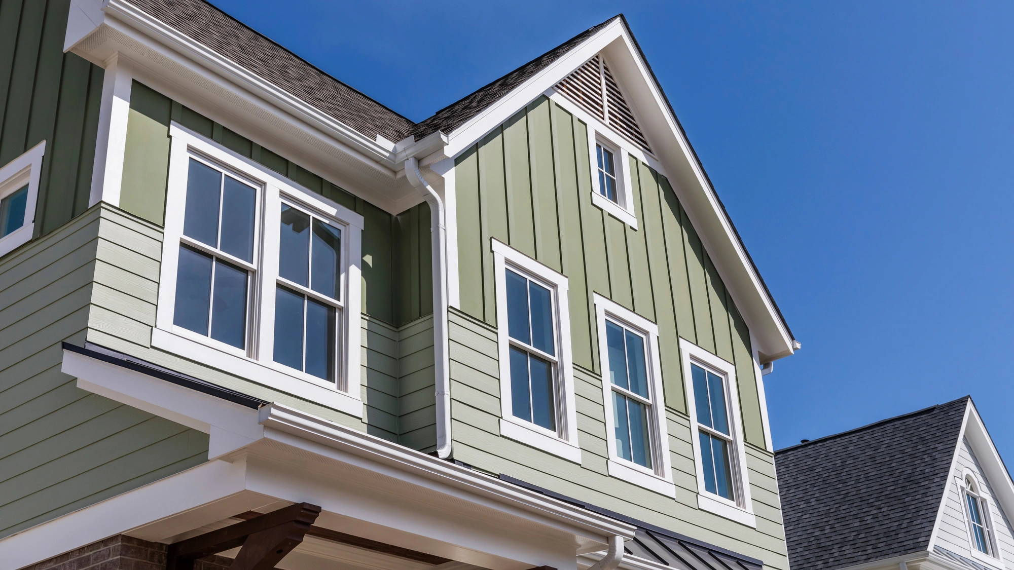 The exterior of a home with green siding and white trim