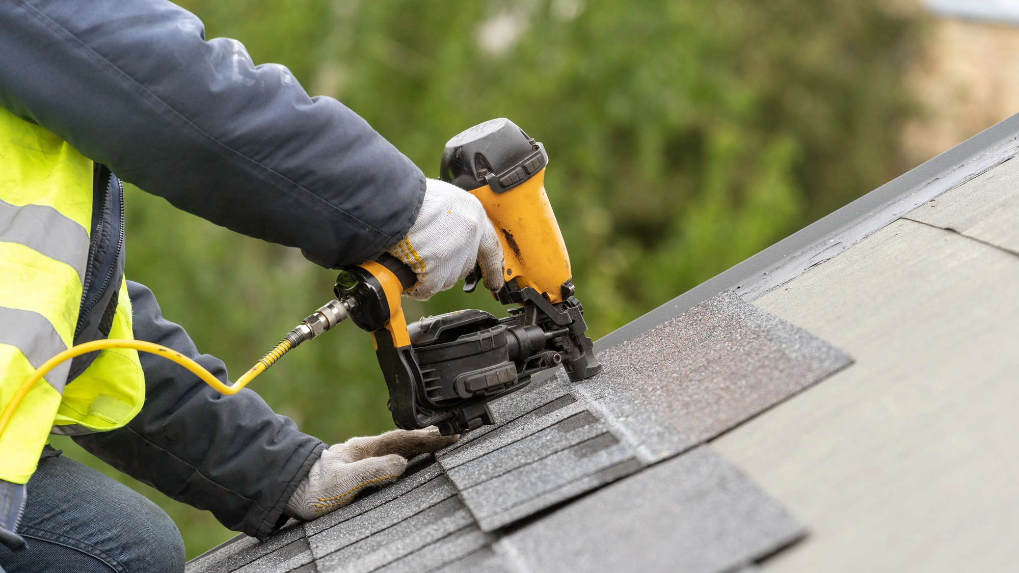 A roofing contractor installing new shingles during a repair