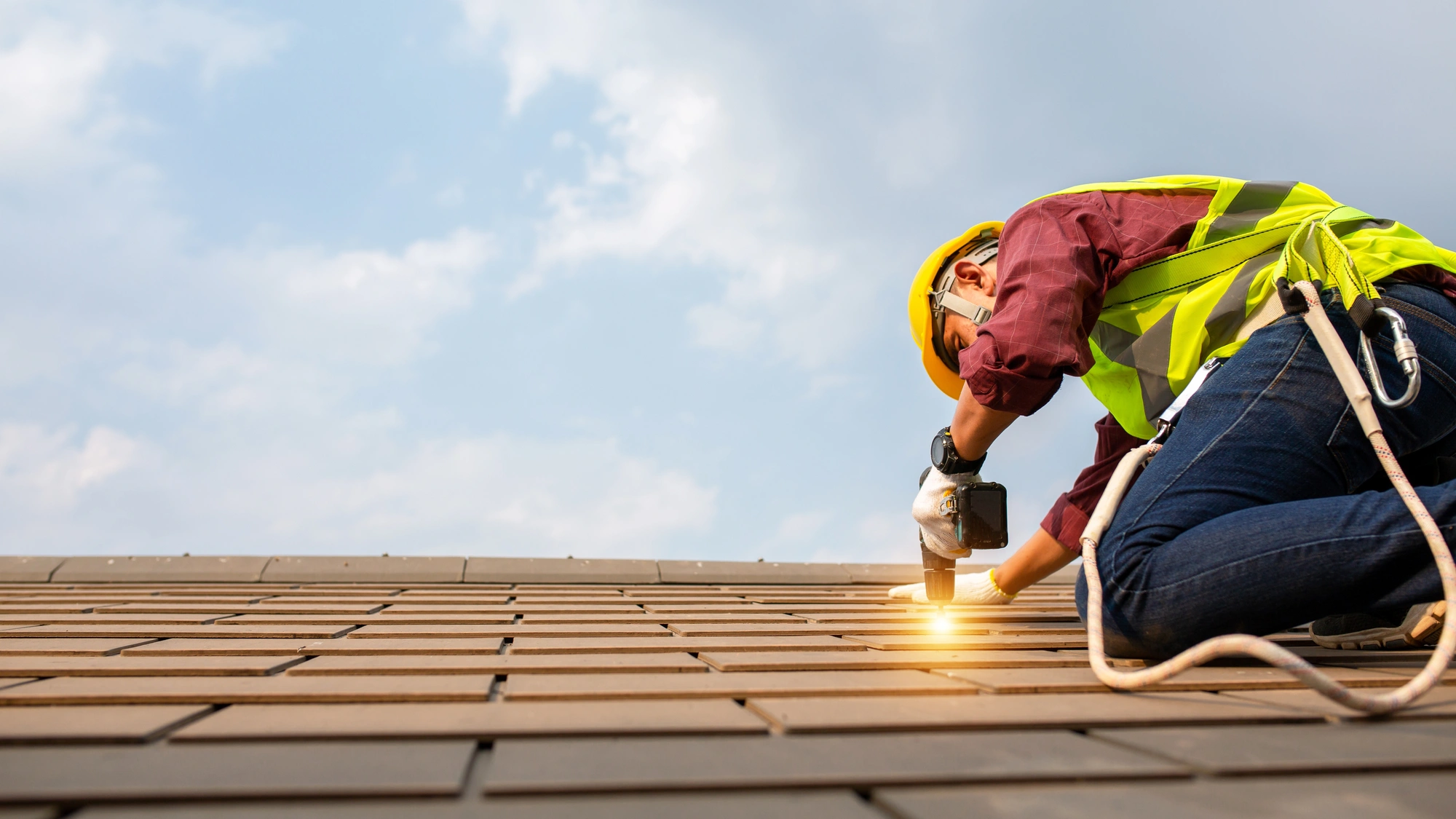 A roofer repairs a commercial roof