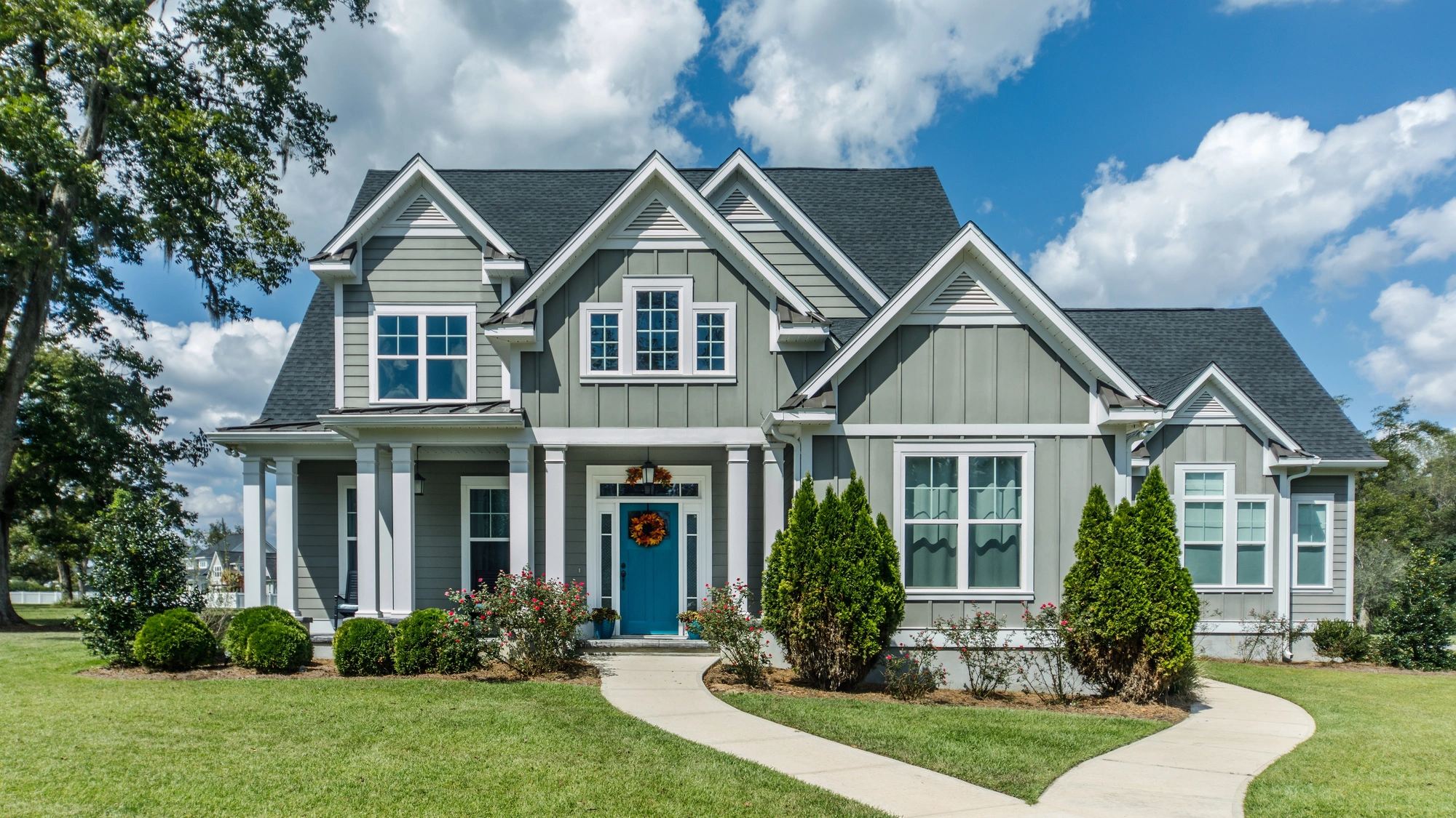 The exterior of a home with green siding and white trim