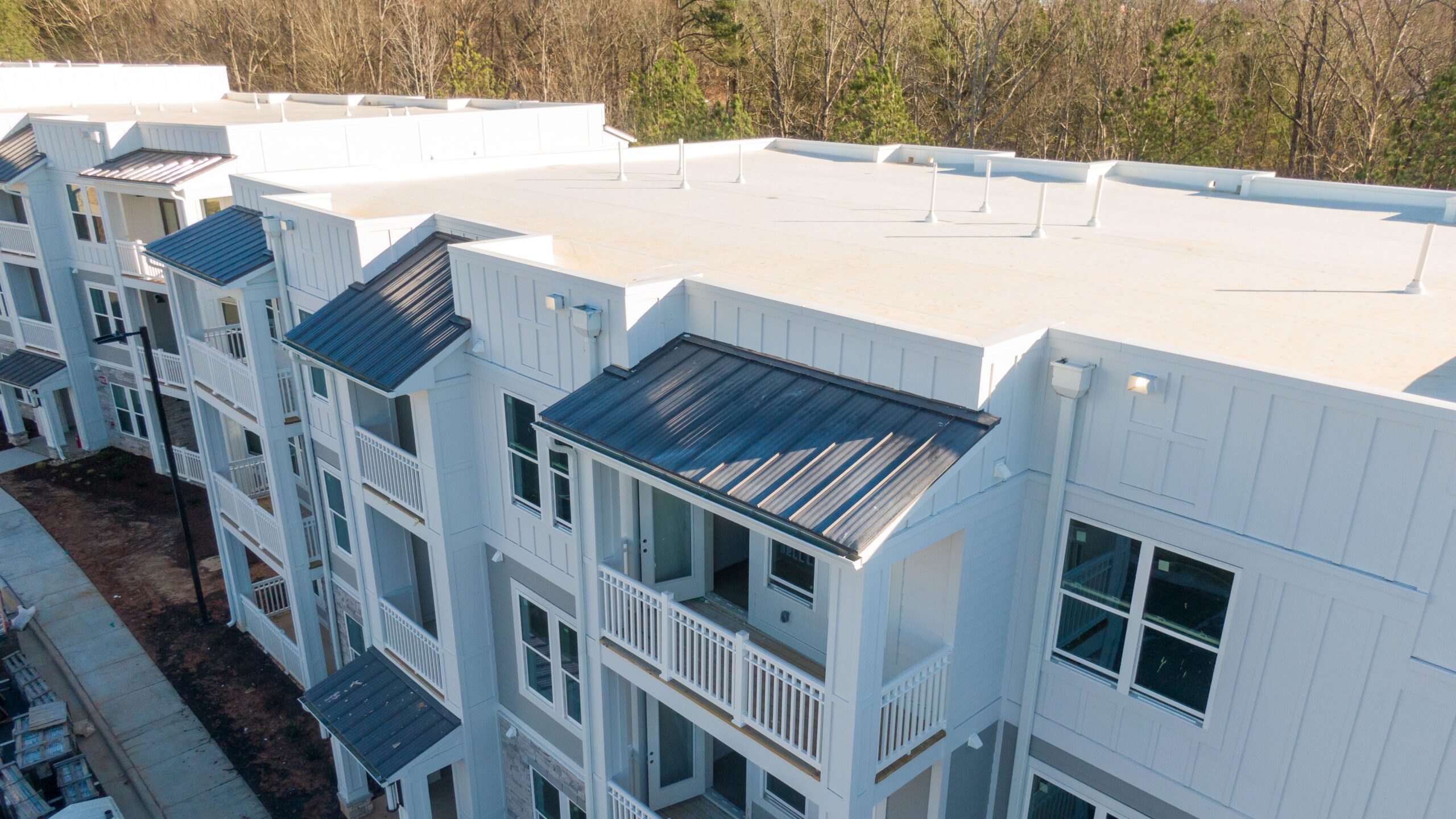 Overhead view of an apartment building with a flat TPO roofing system