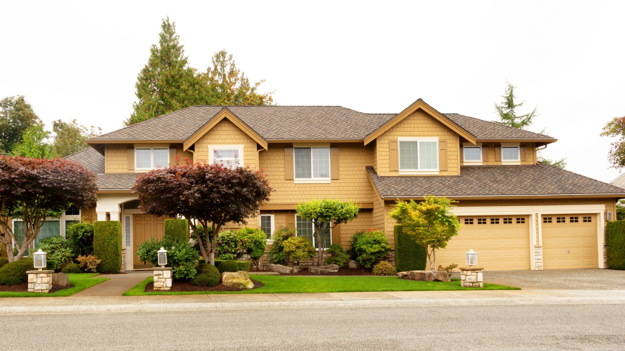 A home with yellow siding and a brown shingle roof