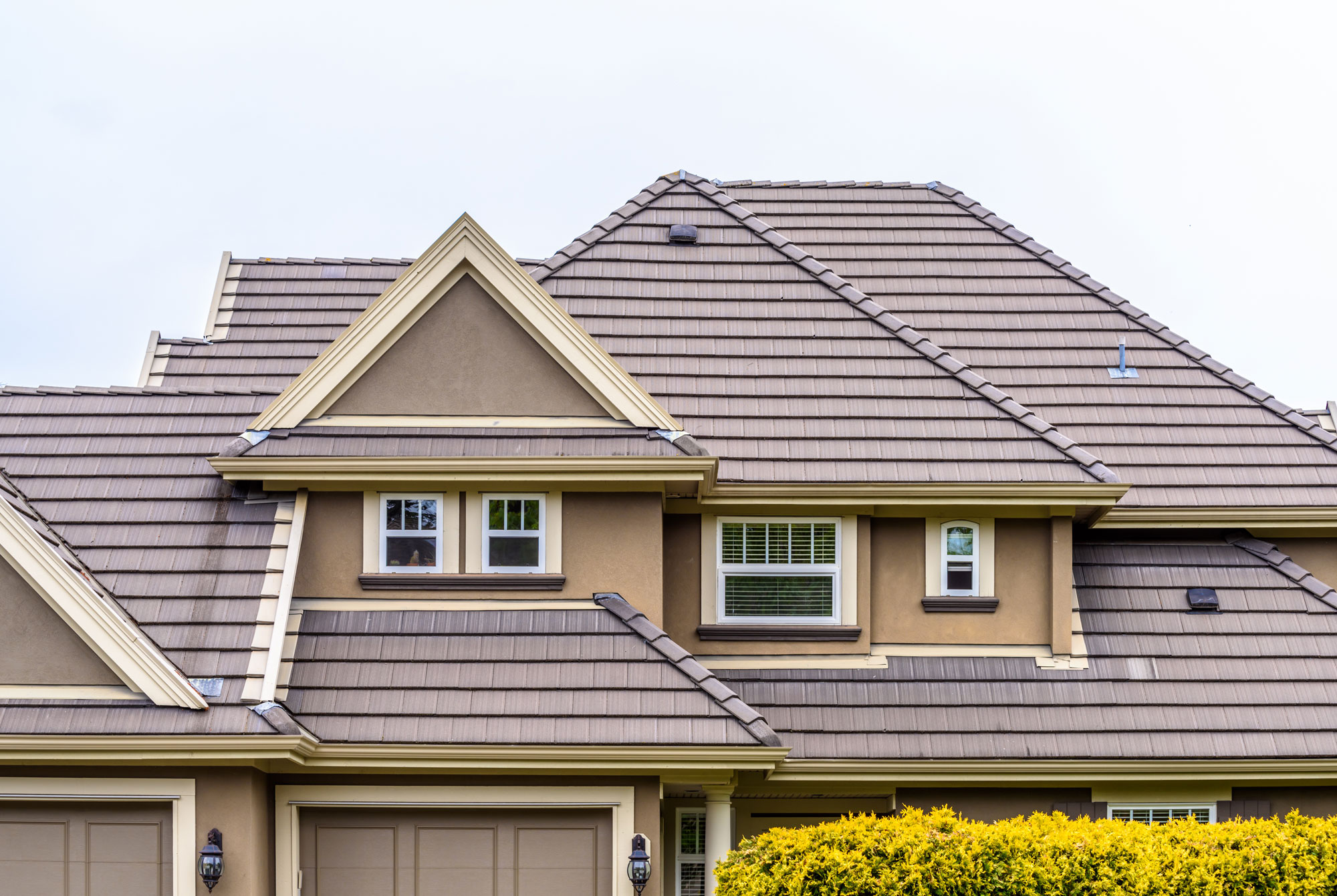 House with stucco siding and brown metal roof