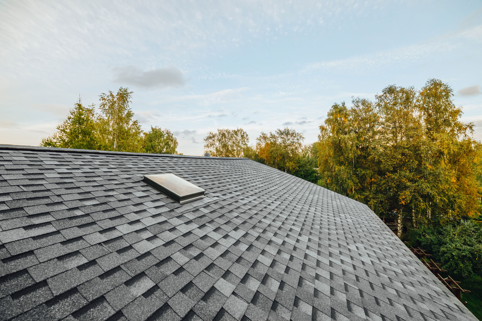 Asphalt shingle roof with skylight