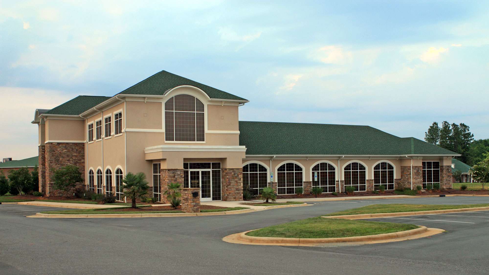 New office building with green asphalt shingle roofing