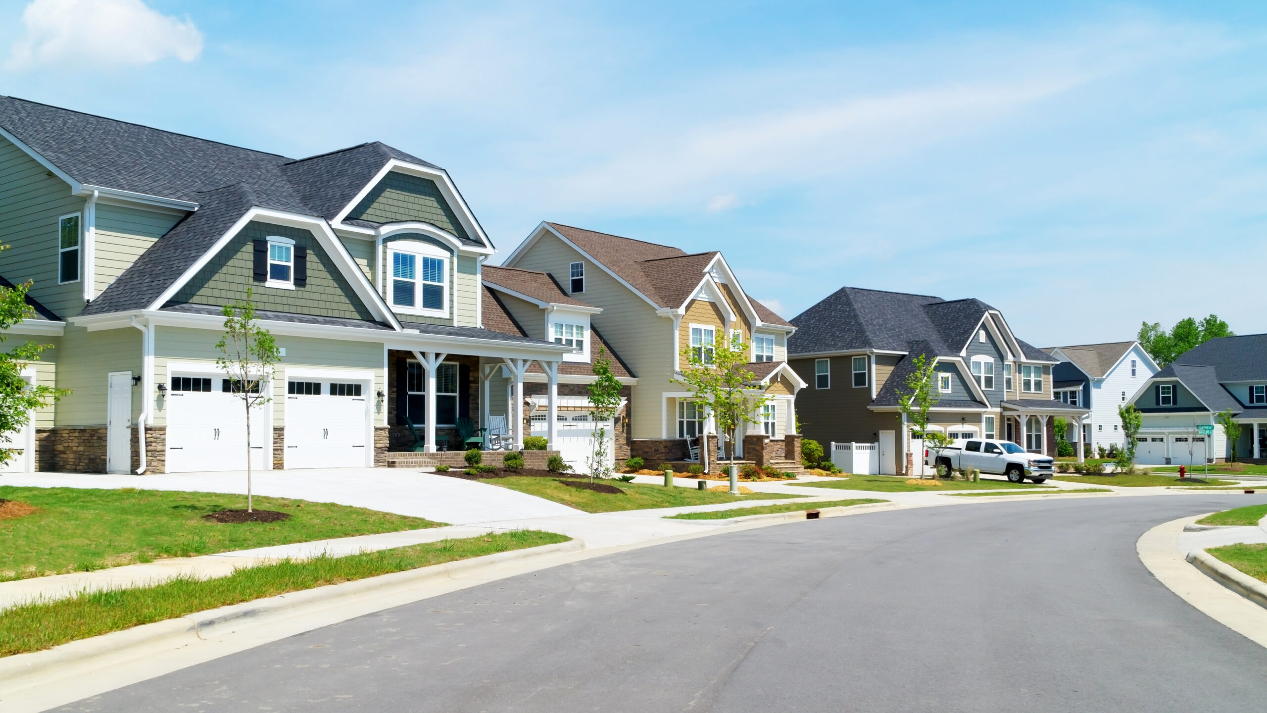 Street of attractive suburban homes with colorful siding