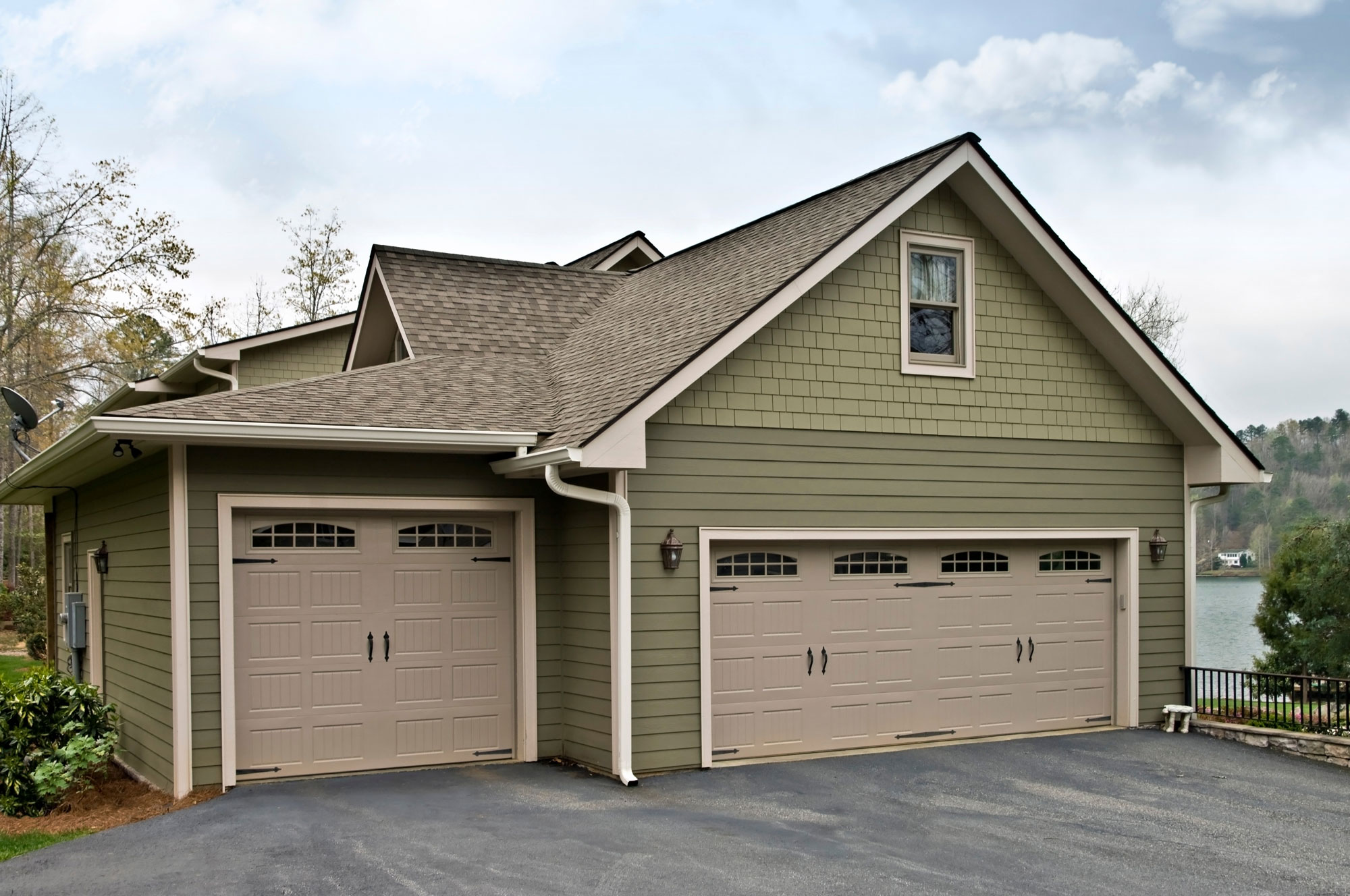 Technician installing beige siding on house