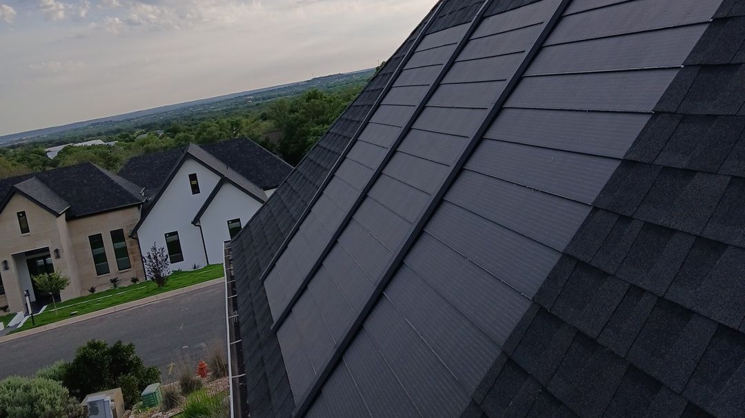 Closeup of the pitch of a shingle roof with solar shingles installed