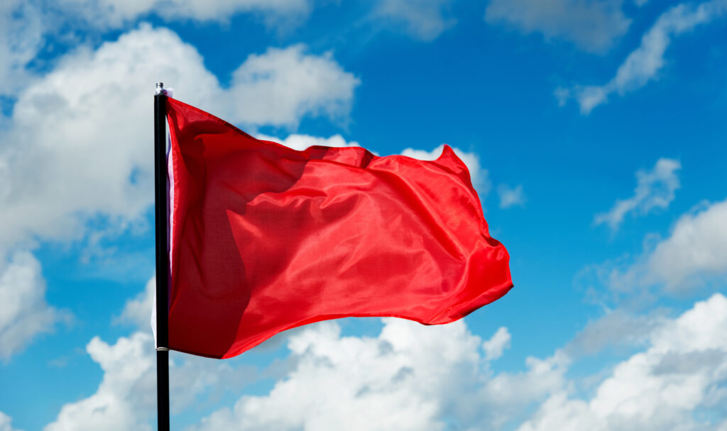 Red flag against blue sky