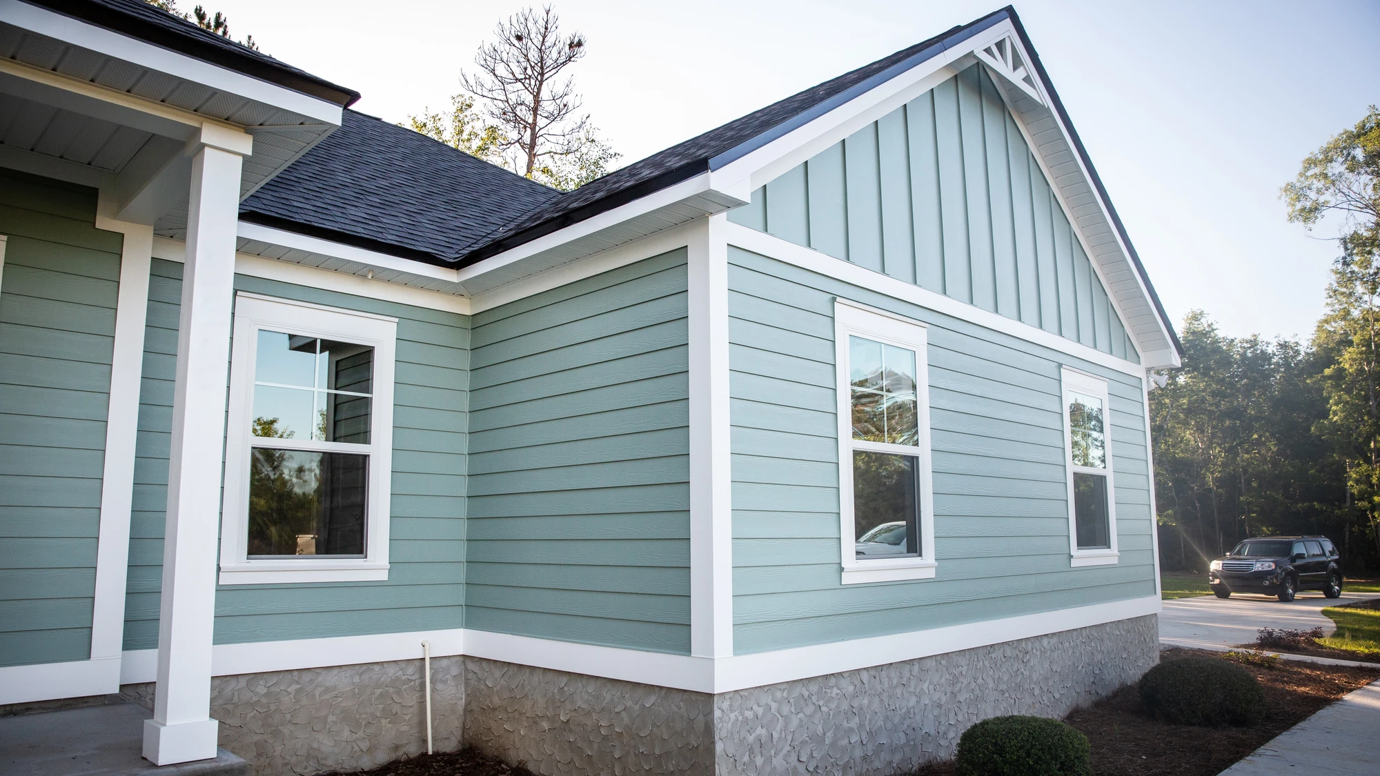 Home with brand new teal exterior siding