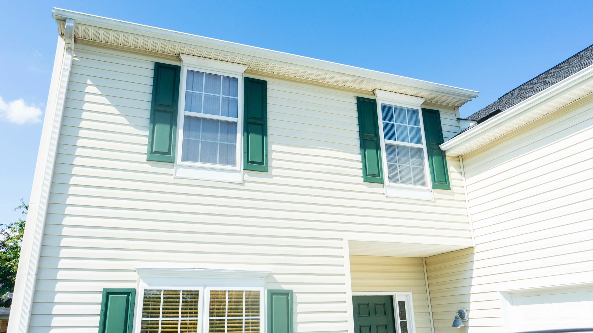 Exterior view of home with newly installed white siding